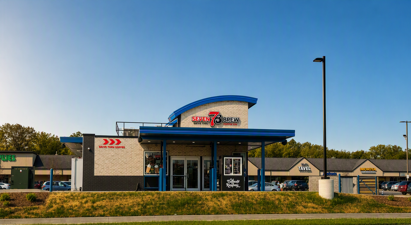 Cars moving through a quick-service restaurant drive-thru lane at an outparcel location